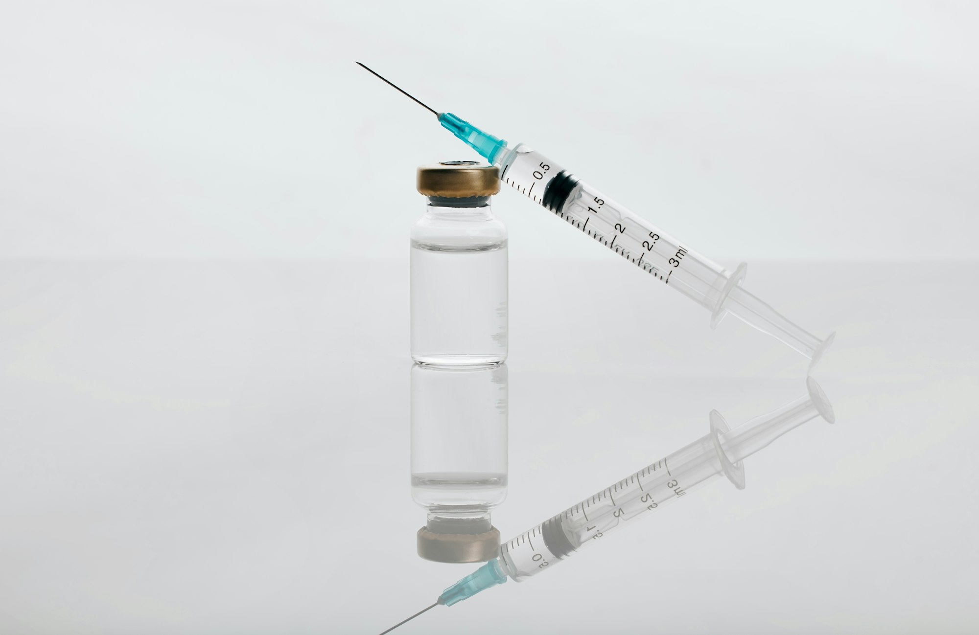 Closeup shot of a vial of medicine and a needle in an empty studio